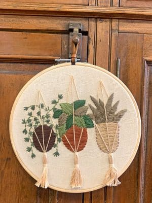 Embroidery Wall Hanging Plants straight on view against wood