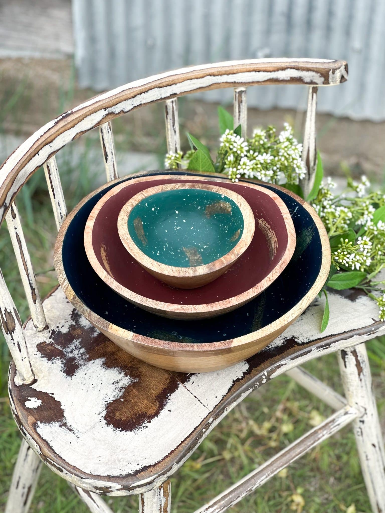 Trio of nested wood melamine bowls with teal, mauve, and navy splatter interiors