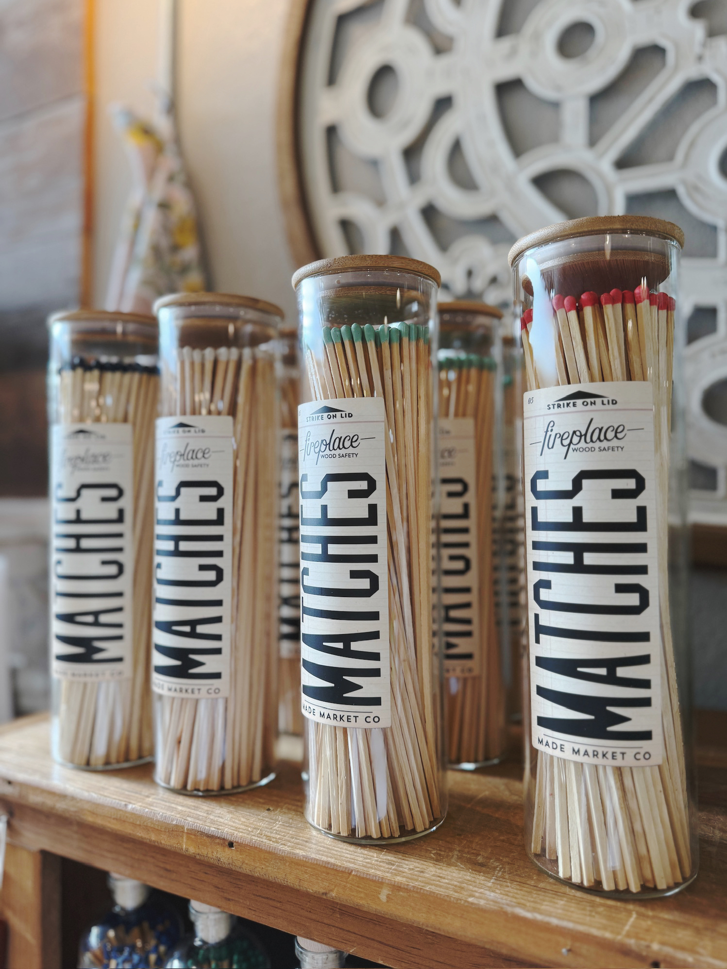 Apothecary Vintage Fireplace Matches in tall glass vessels with wood lids, displayed in multiple color tip options.