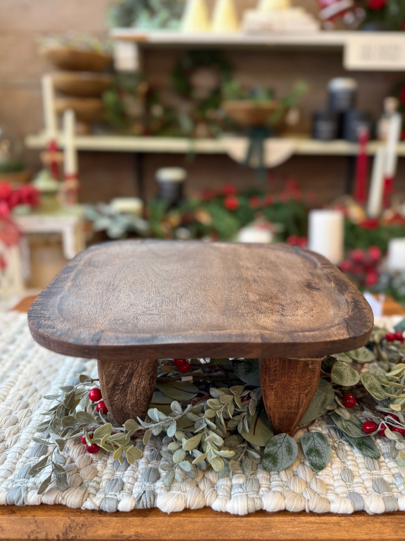 Top-down view of the Square Wood Primitive Stool highlighting the smooth, rounded square surface and natural wood grain.