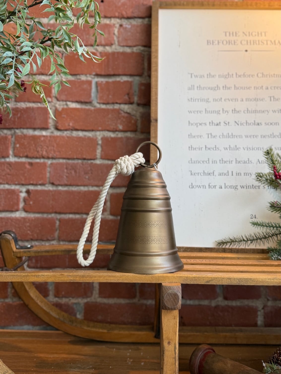 made-market-co-hays-ks-antique-brass-bell-small Antique Brass Bell Small styled on a rustic wooden bench with braided rope hanger.