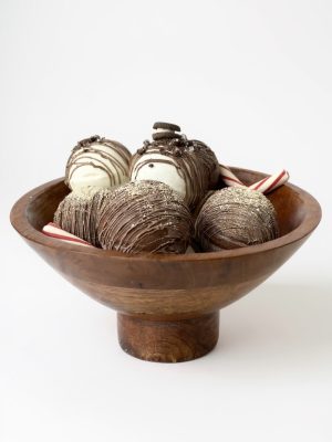 Large mango wood footed bowl filled with chocolate-dipped treats and candy canes, showcasing the bowl’s rich natural grain and elevated pedestal base.