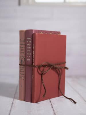 Decorative Vintage Book Set – Valentine’s with three vintage hardback books in pink and red shades, tied with twine