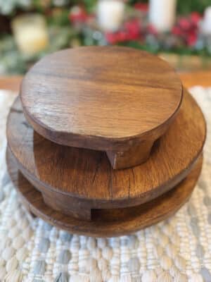 Set of three found wood pedestals in varying heights with natural grain and rustic finish, stacked to showcase their primitive character and handcrafted look.